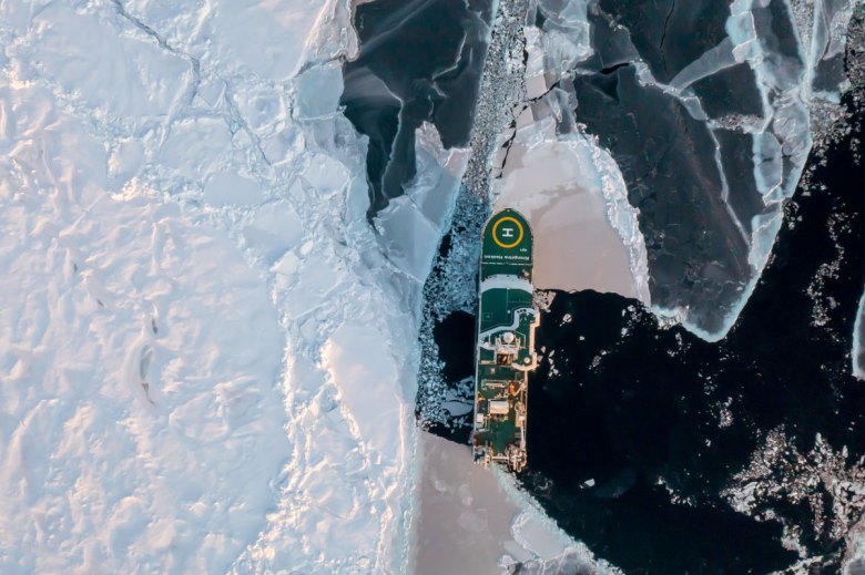 Overhead view of the breaker R/V Kronprins Haakon sailing amid sea ice in the Arctic Ocean.